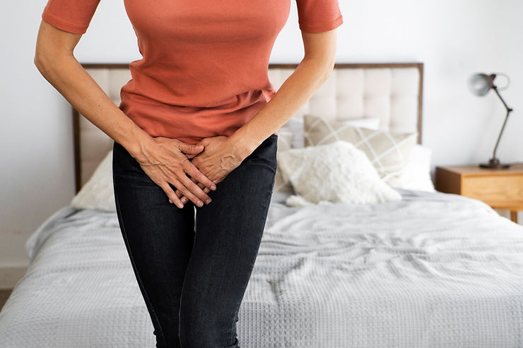 Woman holding her bladder due to urinary incontinence discomfort